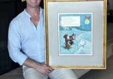 AOIF Executive Director holds Frederick Richardson's original watercolor from the Volland Mother Goose